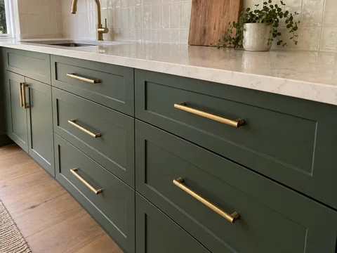 Sample completion photo of green drawers and brass pulls